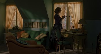 Movie still from “Far from Heaven” (2002), directed by Todd Haynes – A woman standing in front of a window in a living room; Wide shot, High angle