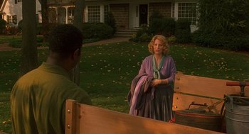 Movie still from “Far from Heaven” (2002), directed by Todd Haynes – A man and a woman standing in front of a house; Wide shot, Over the shoulder angle