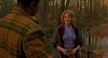 Movie still from “Far from Heaven” (2002), directed by Todd Haynes – A woman holding a plant in her hands; Medium shot, Over the shoulder angle