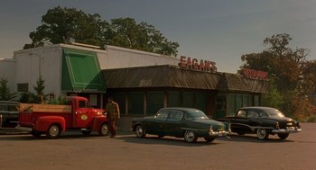 Movie still from “Far from Heaven” (2002), directed by Todd Haynes – An old truck parked in front of a restaurant; Extreme Wide shot, Low angle