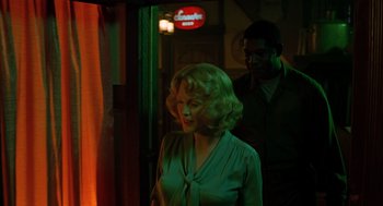 Movie still from “Far from Heaven” (2002), directed by Todd Haynes – A woman standing next to a man in front of a neon sign; Medium shot, Low angle