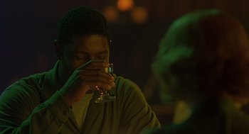 Movie still from “Far from Heaven” (2002), directed by Todd Haynes – A man holding a wine glass in front of his face; Close Up shot, Over the shoulder angle