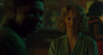 Movie still from “Far from Heaven” (2002), directed by Todd Haynes – A woman with blonde hair is smiling at the camera; Close Up shot, Over the shoulder angle