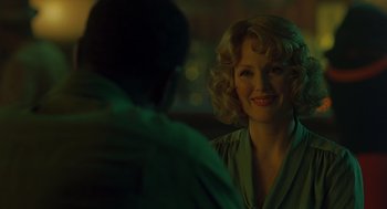 Movie still from “Far from Heaven” (2002), directed by Todd Haynes – A woman sitting in front of a man in a green shirt; Close Up shot, Over the shoulder angle