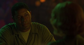 Movie still from “Far from Heaven” (2002), directed by Todd Haynes – A man sitting in front of another man in a dark room; Close Up shot, Over the shoulder angle