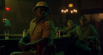 Movie still from “Far from Heaven” (2002), directed by Todd Haynes – A group of men sitting at a table in a room; Medium shot, Low angle