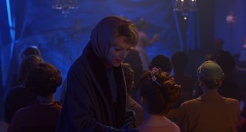 Movie still from “Far from Heaven” (2002), directed by Todd Haynes – A woman in a long coat and a head scarf is talking to a young girl; Medium shot, Over the shoulder angle