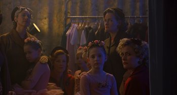 Movie still from “Far from Heaven” (2002), directed by Todd Haynes – A group of women sitting next to each other in a room; Medium shot, Over the shoulder angle