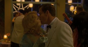 Movie still from “Far from Heaven” (2002), directed by Todd Haynes – A man and a woman kissing at a formal event; Medium shot, Over the shoulder angle