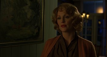 Movie still from “Far from Heaven” (2002), directed by Todd Haynes – A woman in a brown dress and a brown jacket; Close Up shot, Over the shoulder angle