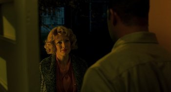 Movie still from “Far from Heaven” (2002), directed by Todd Haynes – An older woman wearing a green jacket talking to a younger man; Medium shot, Over the shoulder angle