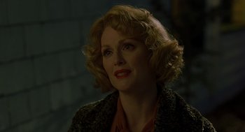 Movie still from “Far from Heaven” (2002), directed by Todd Haynes – A person with curly hair; Close Up shot, Over the shoulder angle
