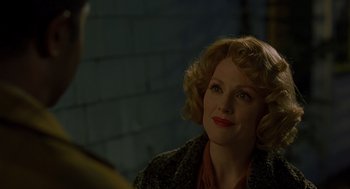 Movie still from “Far from Heaven” (2002), directed by Todd Haynes – A woman sitting in a room with a brick wall behind her; Close Up shot, Over the shoulder angle
