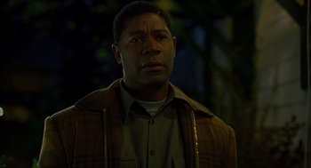 Movie still from “Far from Heaven” (2002), directed by Todd Haynes – A man in a brown jacket is standing in the dark; Close Up shot, Low angle