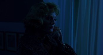 Movie still from “Far from Heaven” (2002), directed by Todd Haynes – A woman talking on a phone in a dark room; Close Up shot, Low angle