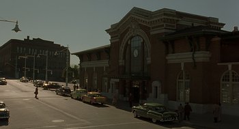 Movie still from “Far from Heaven” (2002), directed by Todd Haynes – A group of cars parked on the side of the street; Extreme Wide shot, Low angle
