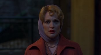 Movie still from “Far from Heaven” (2002), directed by Todd Haynes – A woman wearing a head scarf and a red jacket; Close Up shot, Low angle