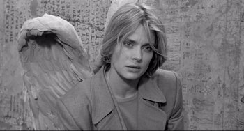 Movie still from “Faraway, So Close!” (1993), directed by Wim Wenders – Black and white photograph of a woman with an angel wing; Close Up shot, High angle