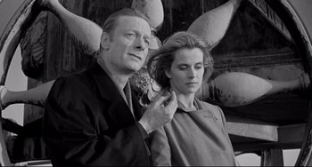 Movie still from “Faraway, So Close!” (1993), directed by Wim Wenders – A man and a woman are combing each other's hair; Close Up shot, Low angle