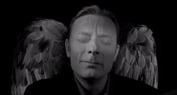 Movie still from “Faraway, So Close!” (1993), directed by Wim Wenders – A black and white photo of a man with his eyes closed; Close Up shot, Overhead angle