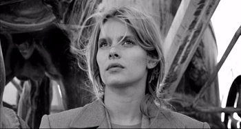 Movie still from “Faraway, So Close!” (1993), directed by Wim Wenders – Black and white photograph of a woman looking to her left; Close Up shot, Low angle