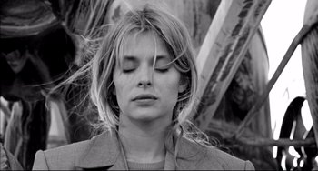 Movie still from “Faraway, So Close!” (1993), directed by Wim Wenders – A black and white photo of a woman with her eyes closed; Close Up shot, Low angle