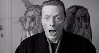 Movie still from “Faraway, So Close!” (1993), directed by Wim Wenders – A man with a surprised look on his face; Close Up shot, Low angle