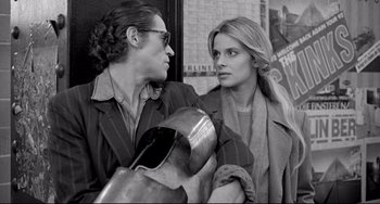 Movie still from “Faraway, So Close!” (1993), directed by Wim Wenders – A man and a woman standing next to each other on the street; Close Up shot, Over the shoulder angle