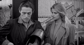 Movie still from “Faraway, So Close!” (1993), directed by Wim Wenders – A man and a woman standing next to each other; Close Up shot, Over the shoulder angle