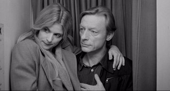 Movie still from “Faraway, So Close!” (1993), directed by Wim Wenders – A man and a woman posing for a picture; Close Up shot, High angle