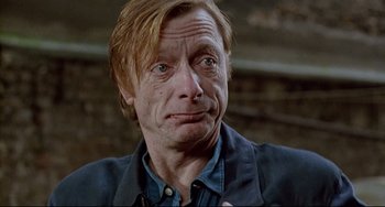 Movie still from “Faraway, So Close!” (1993), directed by Wim Wenders – A person wearing a blue shirt; Close Up shot, Over the shoulder angle