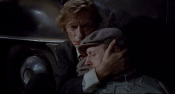 Movie still from “Faraway, So Close!” (1993), directed by Wim Wenders – A man and a woman are hugging in the back of a car; Close Up shot, Overhead angle