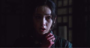 Movie still from “Farewell My Concubine” (1992), directed by Kaige Chen – A young woman with dark hair and red lipstick; Close Up shot, Over the shoulder angle