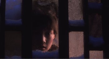 Movie still from “Farewell My Concubine” (1992), directed by Kaige Chen – A young girl looking through a window at the camera; Close Up shot, Low angle