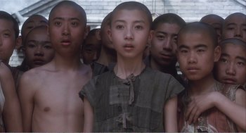Movie still from “Farewell My Concubine” (1992), directed by Kaige Chen – A group of young men standing next to each other; Medium shot, Low angle