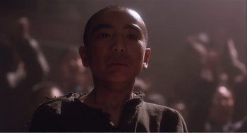 Movie still from “Farewell My Concubine” (1992), directed by Kaige Chen – A young man is looking into the distance; Close Up shot, Low angle