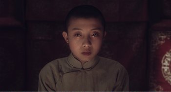 Movie still from “Farewell My Concubine” (1992), directed by Kaige Chen – A young boy wearing a traditional chinese outfit; Close Up shot, High angle