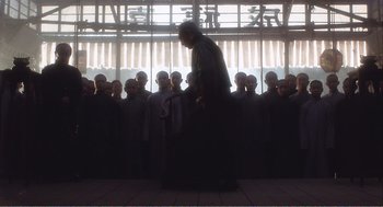 Movie still from “Farewell My Concubine” (1992), directed by Kaige Chen – A group of people standing in front of a window; Wide shot, Low angle