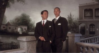 Movie still from “Farewell My Concubine” (1992), directed by Kaige Chen – Two men in suits standing next to each other in front of a wall; Medium shot, Low angle