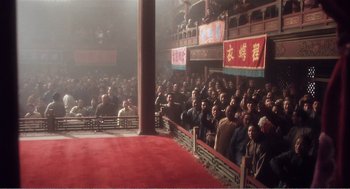 Movie still from “Farewell My Concubine” (1992), directed by Kaige Chen – A group of people standing in front of an audience; Extreme Wide shot, Low angle