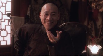 Movie still from “Farewell My Concubine” (1992), directed by Kaige Chen – A man smiling and making a peace sign with his hand; Close Up shot, High angle