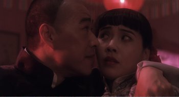 Movie still from “Farewell My Concubine” (1992), directed by Kaige Chen – A man and a woman are kissing in a room; Close Up shot, Over the shoulder angle