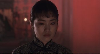 Movie still from “Farewell My Concubine” (1992), directed by Kaige Chen – A young woman in a black and white dress; Close Up shot, Over the shoulder angle