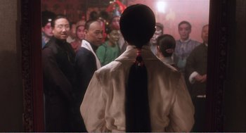 Movie still from “Farewell My Concubine” (1992), directed by Kaige Chen – A group of people standing in front of a crowd; Medium shot, Over the shoulder angle