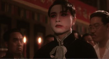 Movie still from “Farewell My Concubine” (1992), directed by Kaige Chen – A man with a black mask and white shirt; Close Up shot, Over the shoulder angle