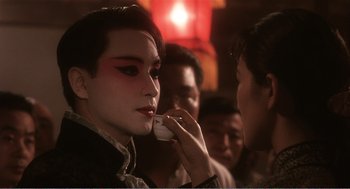 Movie still from “Farewell My Concubine” (1992), directed by Kaige Chen – A man with a face paint talking on a cell phone; Close Up shot, Over the shoulder angle