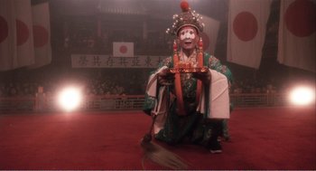 Movie still from “Farewell My Concubine” (1992), directed by Kaige Chen – A person dressed in a costume sitting on the ground; Wide shot, Low angle