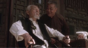 Movie still from “Farewell My Concubine” (1992), directed by Kaige Chen – An older man sitting next to an older gentleman; Medium shot, Low angle