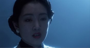 Movie still from “Farewell My Concubine” (1992), directed by Kaige Chen – A woman's face in the dark; Close Up shot, Over the shoulder angle