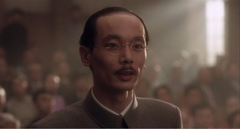 Movie still from “Farewell My Concubine” (1992), directed by Kaige Chen – An asian man with a mustache wearing a suit; Close Up shot, Low angle